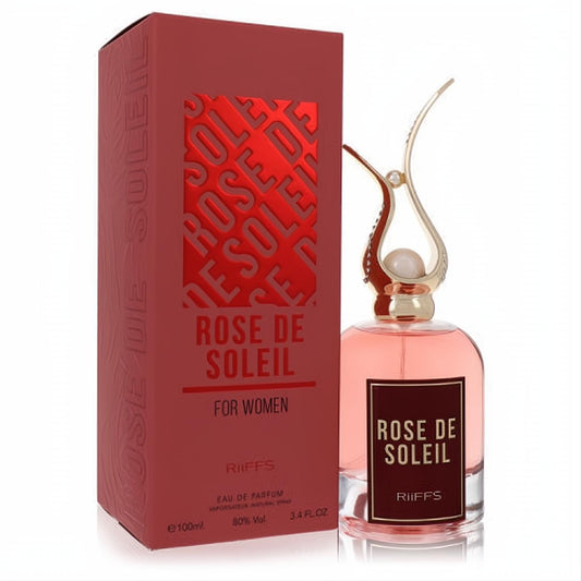 Riiffs Rose De Soleil 3.4 oz Eau De Parfum. Radiant pink fragrance in a clear bottle with an elegant gold ornate cap, next to its deep red box.