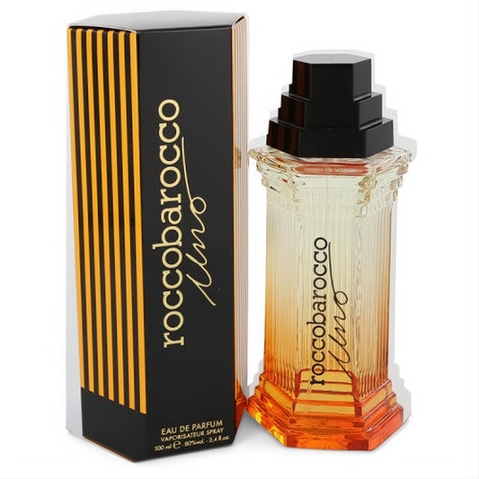 Captivating Roccobarocco Uno 3.4 oz EDP. Fluted glass bottle with warm ombre orange liquid & black tiered cap, beside its striped box.