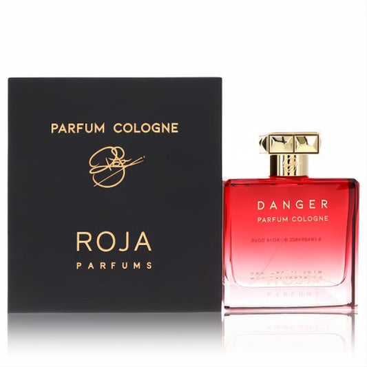 Bold Roja Danger Pour Homme men's fragrance. Striking red glass bottle with gold cap, beside its elegant black Roja Parfums box.