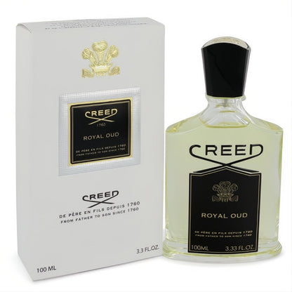 Luxurious Creed Royal Oud 3.3 oz unisex Eau De Parfum spray bottle with amber liquid and sleek black cap, beside its elegant white and gold box.
