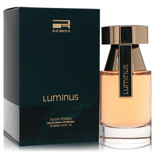 Rue Broca Luminus 3.4 oz Eau De Parfum. Luxurious amber fragrance in a sleek bottle with gold cap, presented with its sophisticated dark teal box.