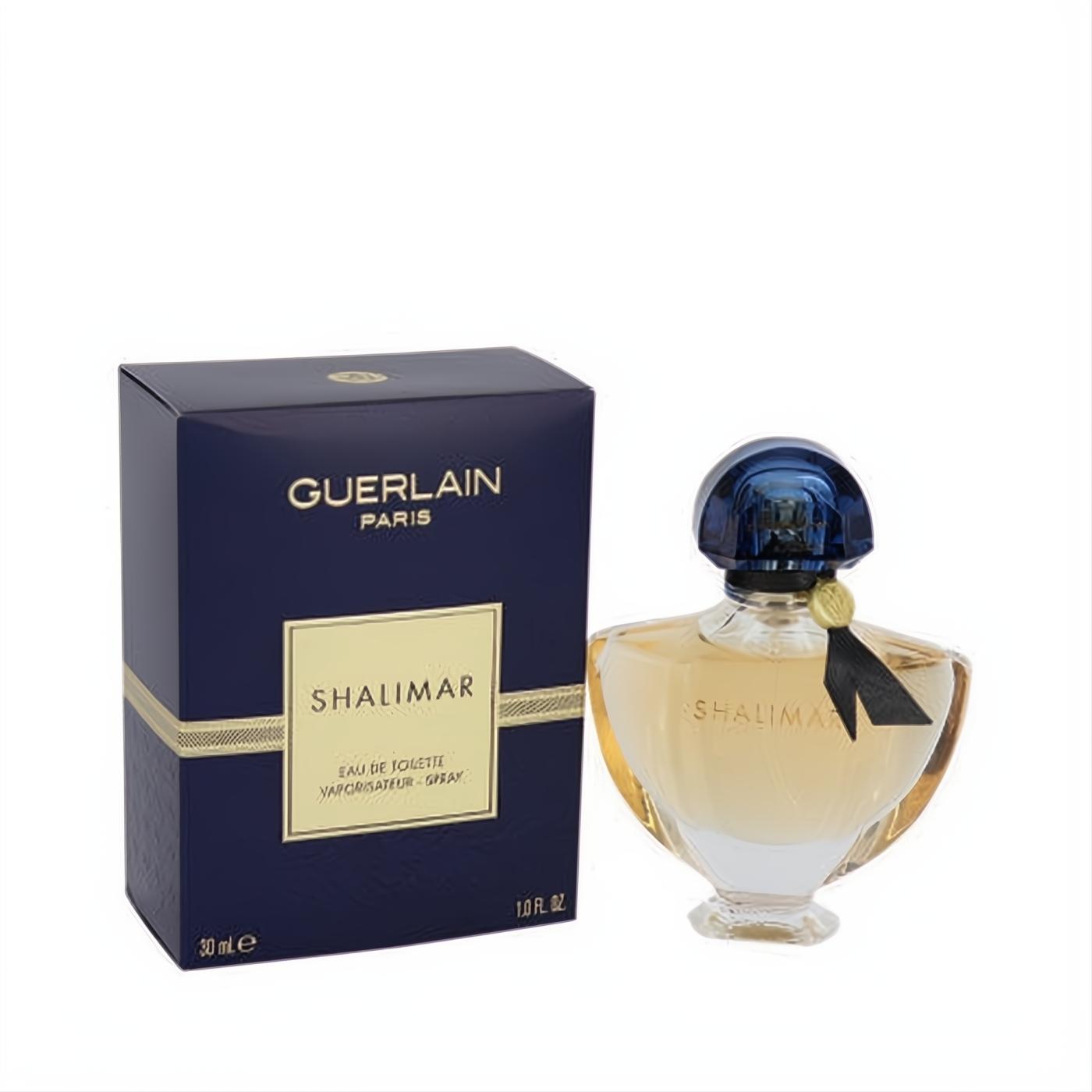 Guerlain Shalimar 1 oz EDT spray. Elegant clear glass bottle with golden liquid, blue cap, black ribbon, and navy box.