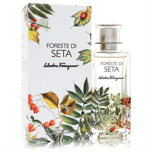 Luxurious Salvatore Ferragamo Foreste Di Seta 3.4 oz unisex Eau De Parfum. Clear bottle and white box with vibrant botanical leaf and berry art.