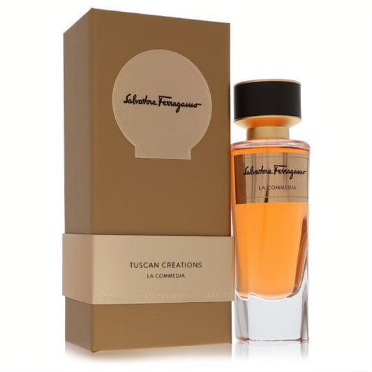 Elegant Salvatore Ferragamo La Commedia 3.3 oz unisex EDP, vibrant orange liquid in a clear glass bottle with gold accents and a matching brown luxury box.