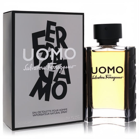 Salvatore Ferragamo Uomo 3.4 oz EDT. Elegant clear glass bottle with amber liquid, black textured sides, and a sleek grey box with bold branding.