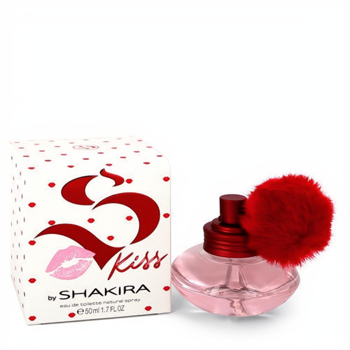 Shakira S Kiss 1.7 oz Eau de Toilette: a playful pink glass bottle with a vibrant red pom-pom, beside its iconic polka dot box.