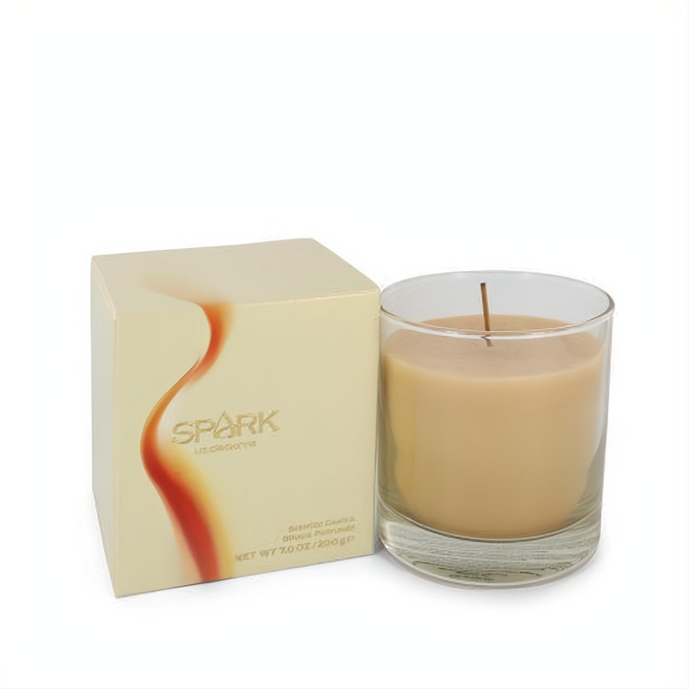 Spark by Liz Claiborne 7 oz scented candle. Warm beige wax in clear glass, beside its cream box with a fiery orange design.