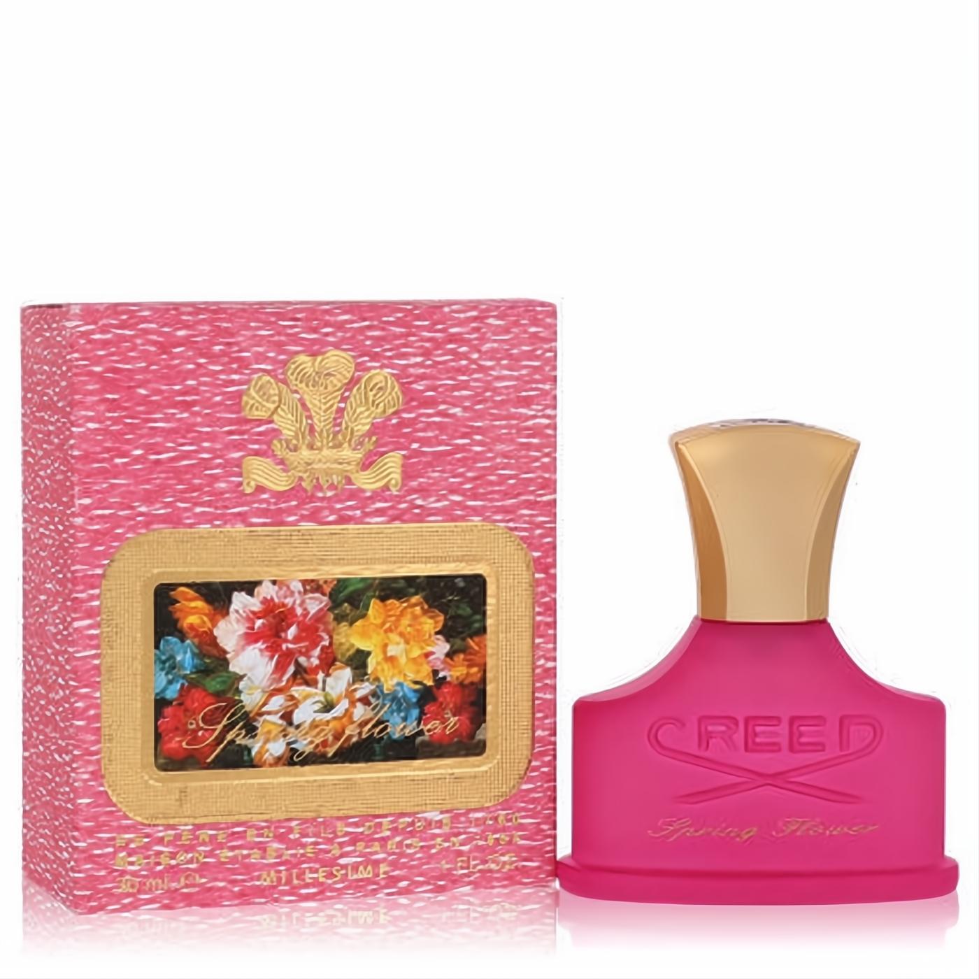 Luxurious Creed Spring Flower 1 oz EDP in a vibrant fuchsia frosted bottle with an elegant gold cap, beside its pink floral gift box.
