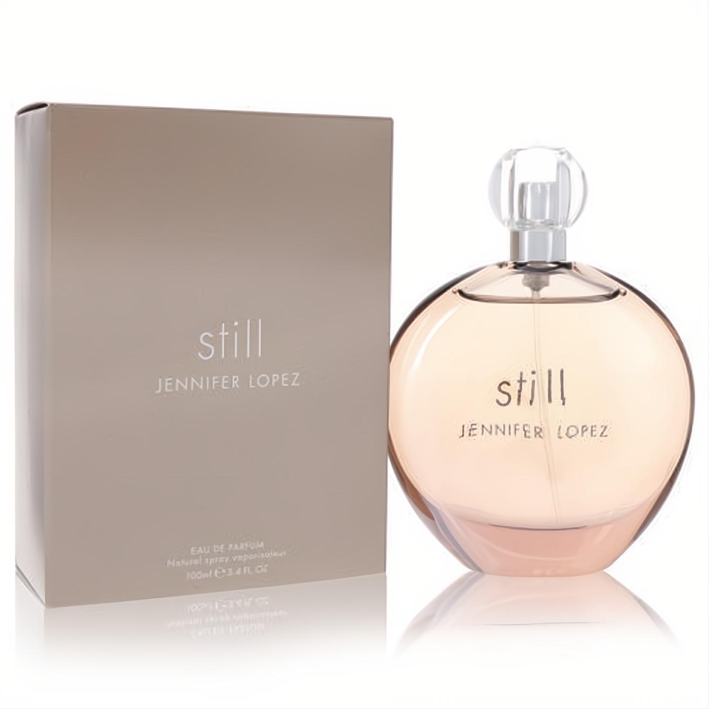 Still by Jennifer Lopez 3.4 oz EDP. Elegant round glass bottle with blush liquid, displayed with its chic tan box.