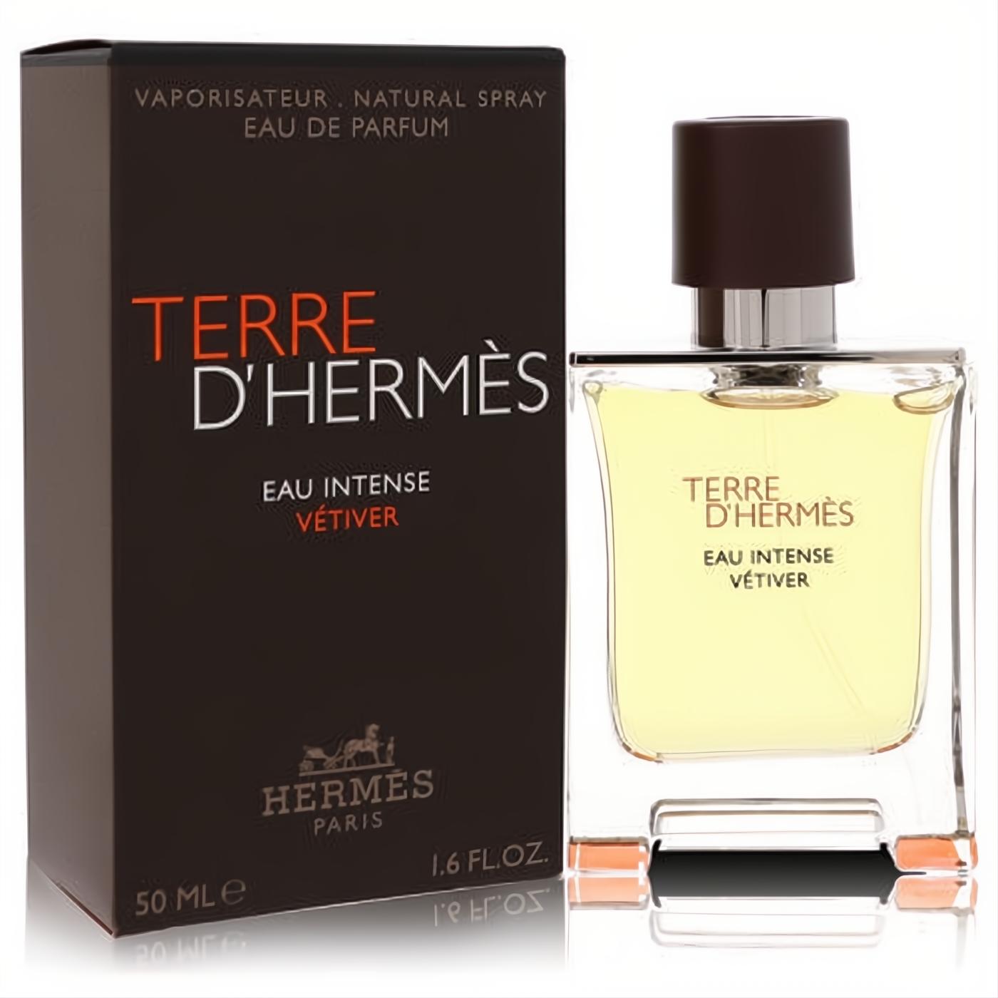 Terre D'hermes Eau Intense Vetiver 1.6 oz EDP. Clear glass bottle with warm amber liquid, dark brown cap, and elegant brown box.