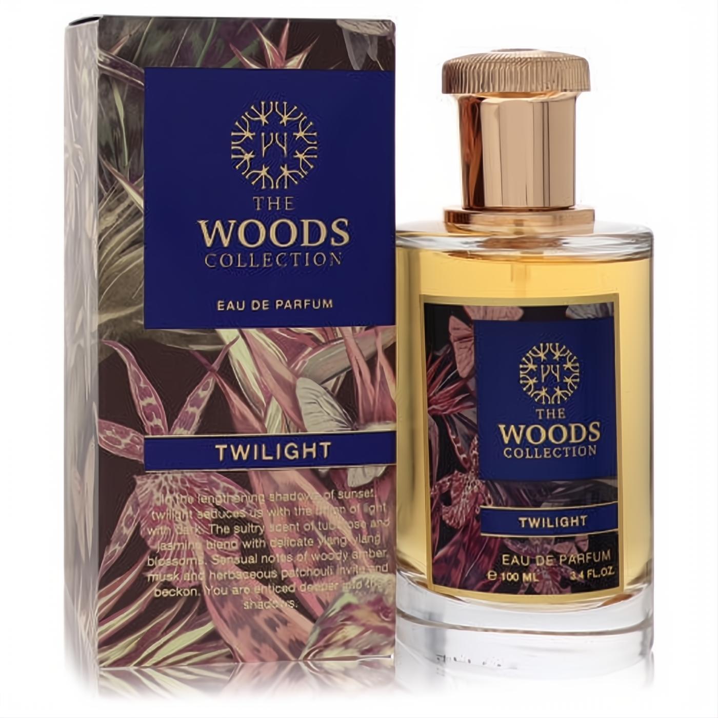 Luxurious The Woods Collection Twilight unisex Eau de Parfum, 3.4 oz. Clear bottle with amber liquid, rose gold cap, and a dark blue botanical box.