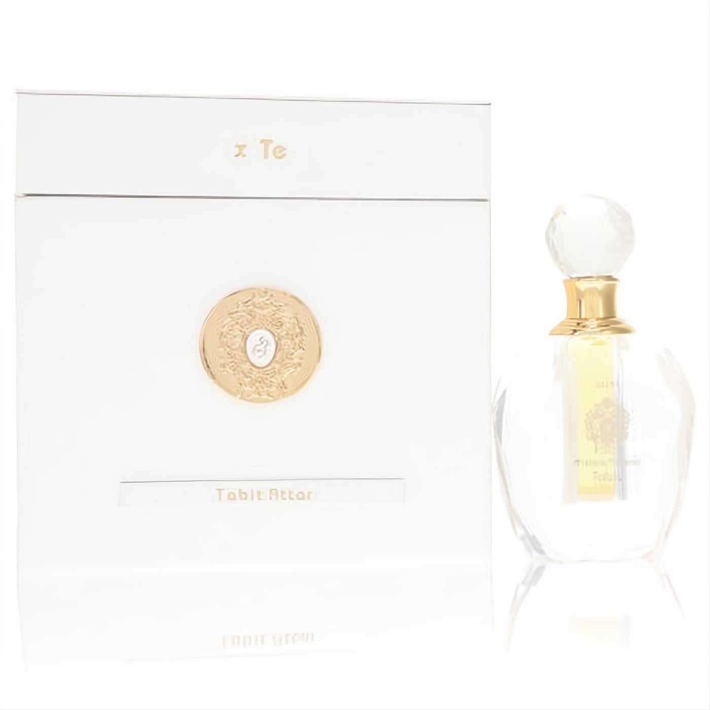 Exquisite Tiziana Terenzi Tabit Attar in a clear glass bottle with crystal cap, beside its luxurious white and gold box.