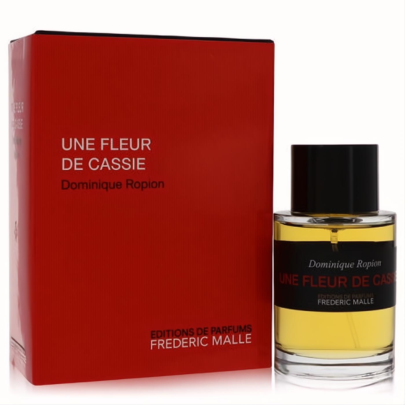 Elegant Frederic Malle Une Fleur De Cassie 3.4 oz Eau De Parfum. Red box and clear glass bottle with black cap, revealing golden fragrance.