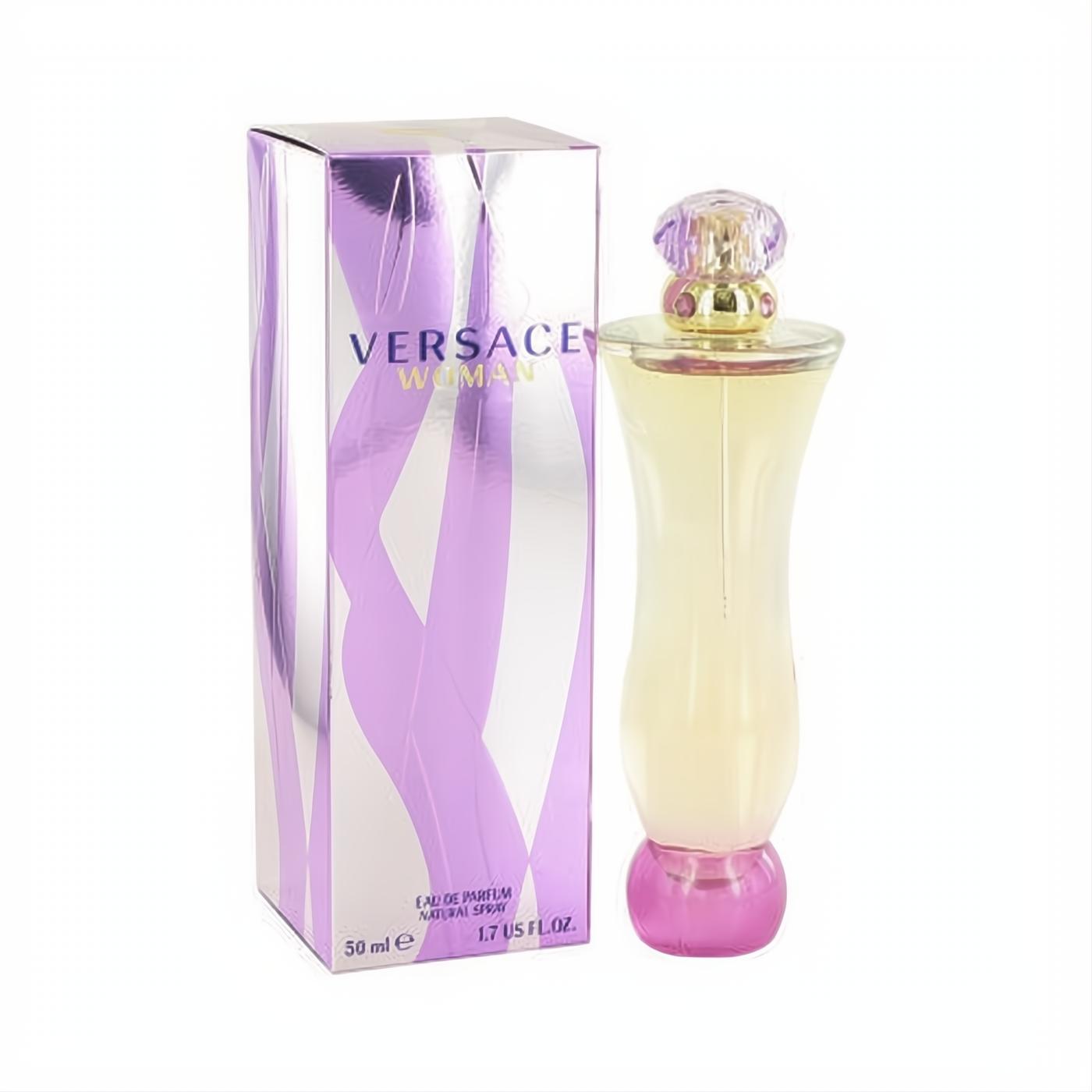 Elegant Versace Woman 1.7 oz Eau de Parfum bottle with light yellow liquid, pink base, and ornate cap, beside its shimmering purple box.