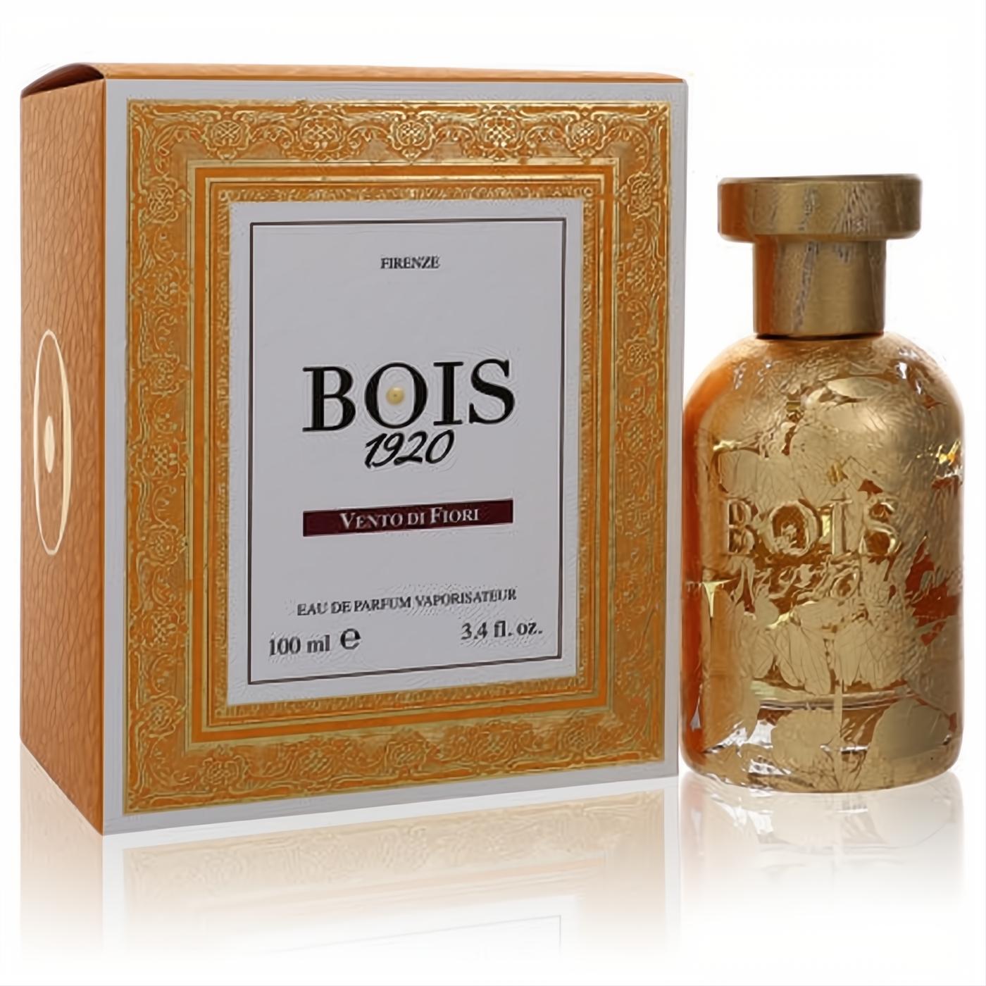 Elegant Bois 1920 Vento Di Fiori 3.4 oz women's EDP. Gold bottle with intricate leaf design, beside an ornate gold-framed orange box.