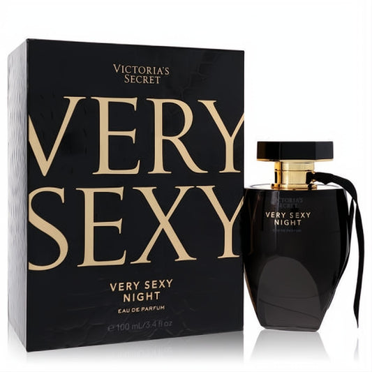 Victoria's Secret Very Sexy Night 3.4 oz Eau de Parfum. Sleek black bottle with gold accents and ribbon, beside its elegant black and gold box.