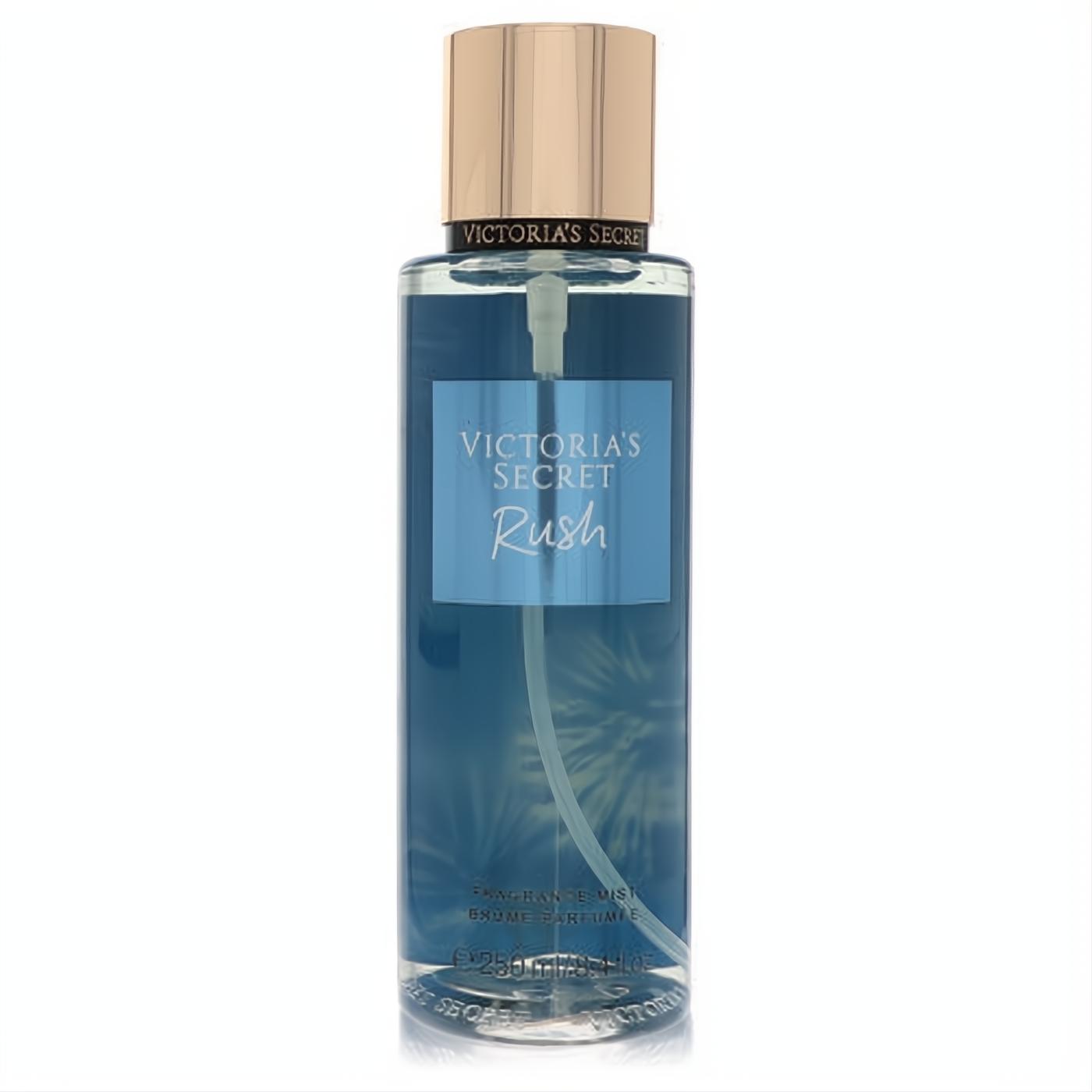 Victoria's Secret Rush 8.4 oz fragrance mist. Clear bottle, vibrant blue liquid, and elegant rose gold cap for women.