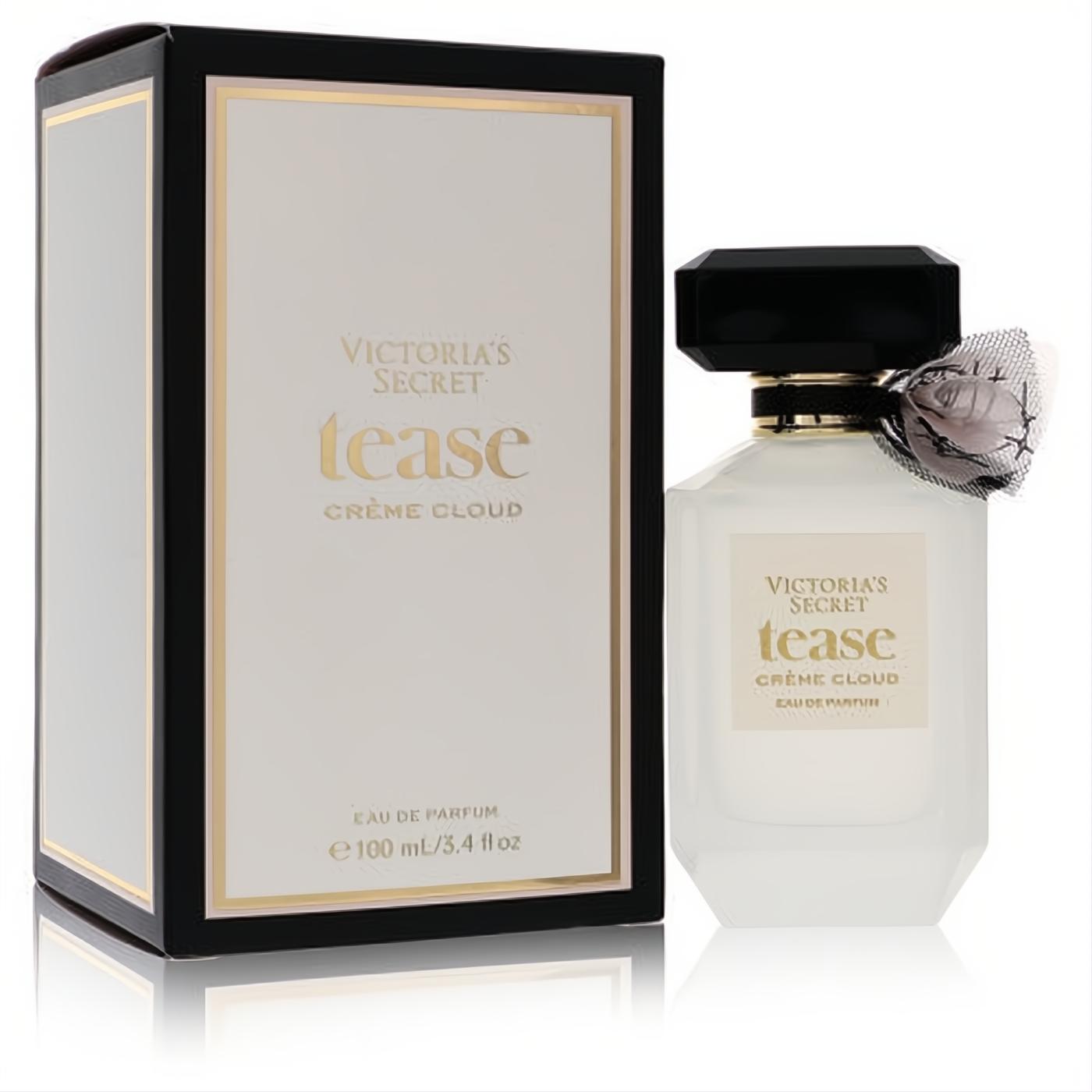 Tease Creme Cloud 3.4 oz EDP. Frosted white bottle with black cap, gold accent, and sheer bow, next to its elegant cream & black box.