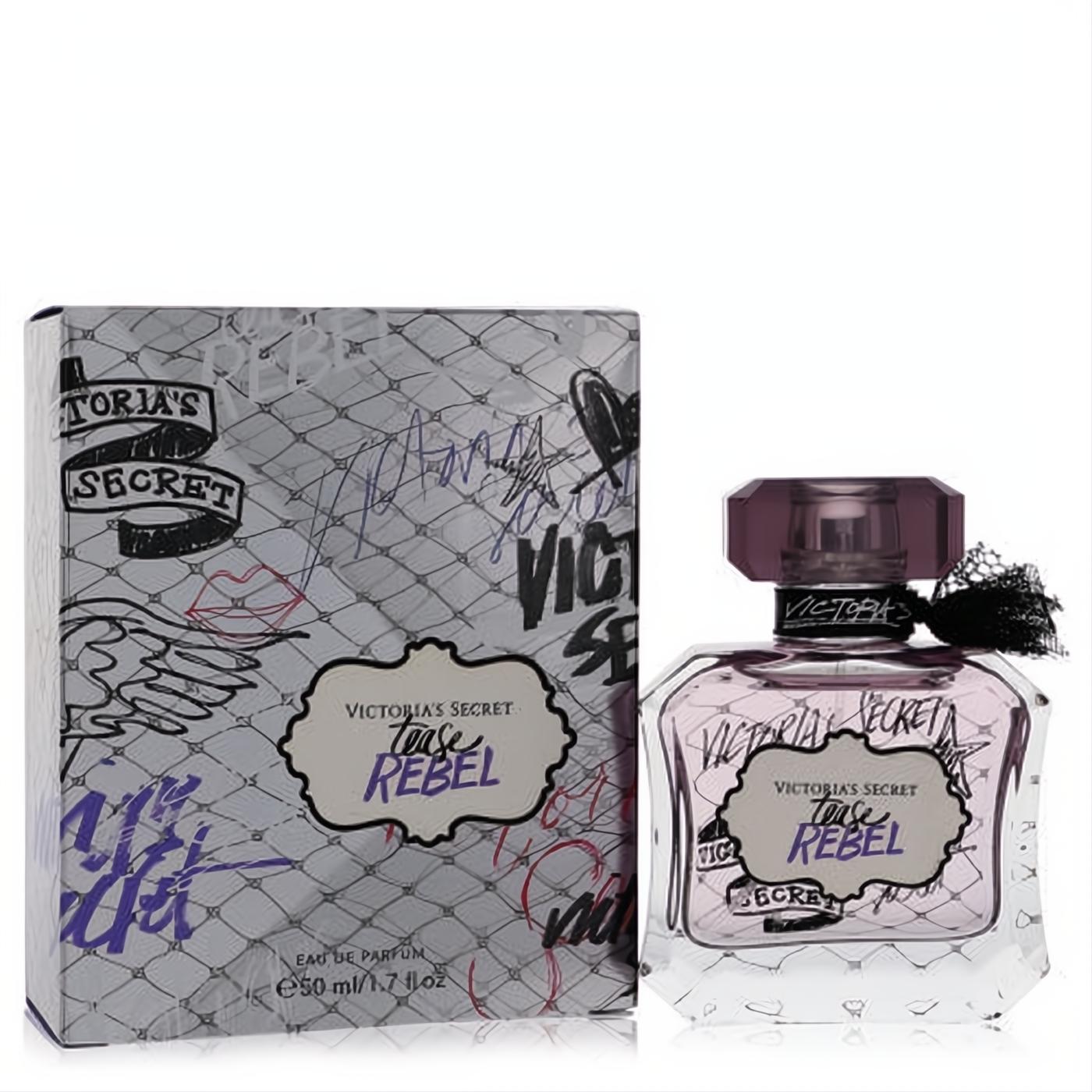 Victoria's Secret Tease Rebel 1.7 oz EDP. Clear faceted bottle with alluring purple liquid, black ribbon, and edgy graffiti-print box.