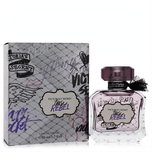 Victoria's Secret Tease Rebel 1.7 oz EDP. Clear faceted bottle with alluring purple liquid, black ribbon, and edgy graffiti-print box.