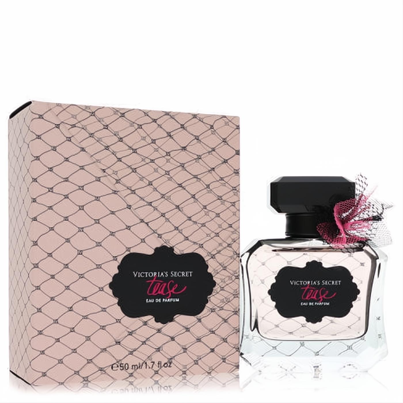 Alluring Victoria's Secret Tease 1.7 oz EDP spray. Clear bottle with black cap, pink lace bow, and matching pink fishnet box.