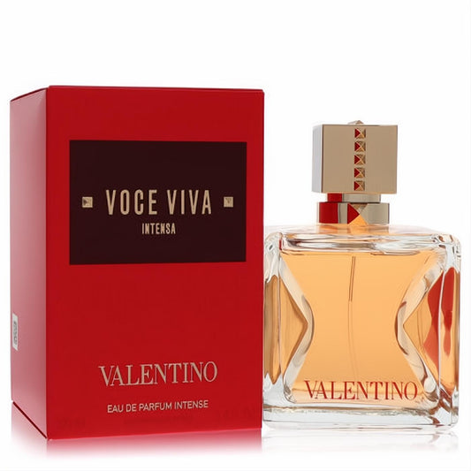 Vibrant red Valentino Voce Viva Intensa Eau de Parfum box and elegant clear bottle with amber liquid and gold studded cap.