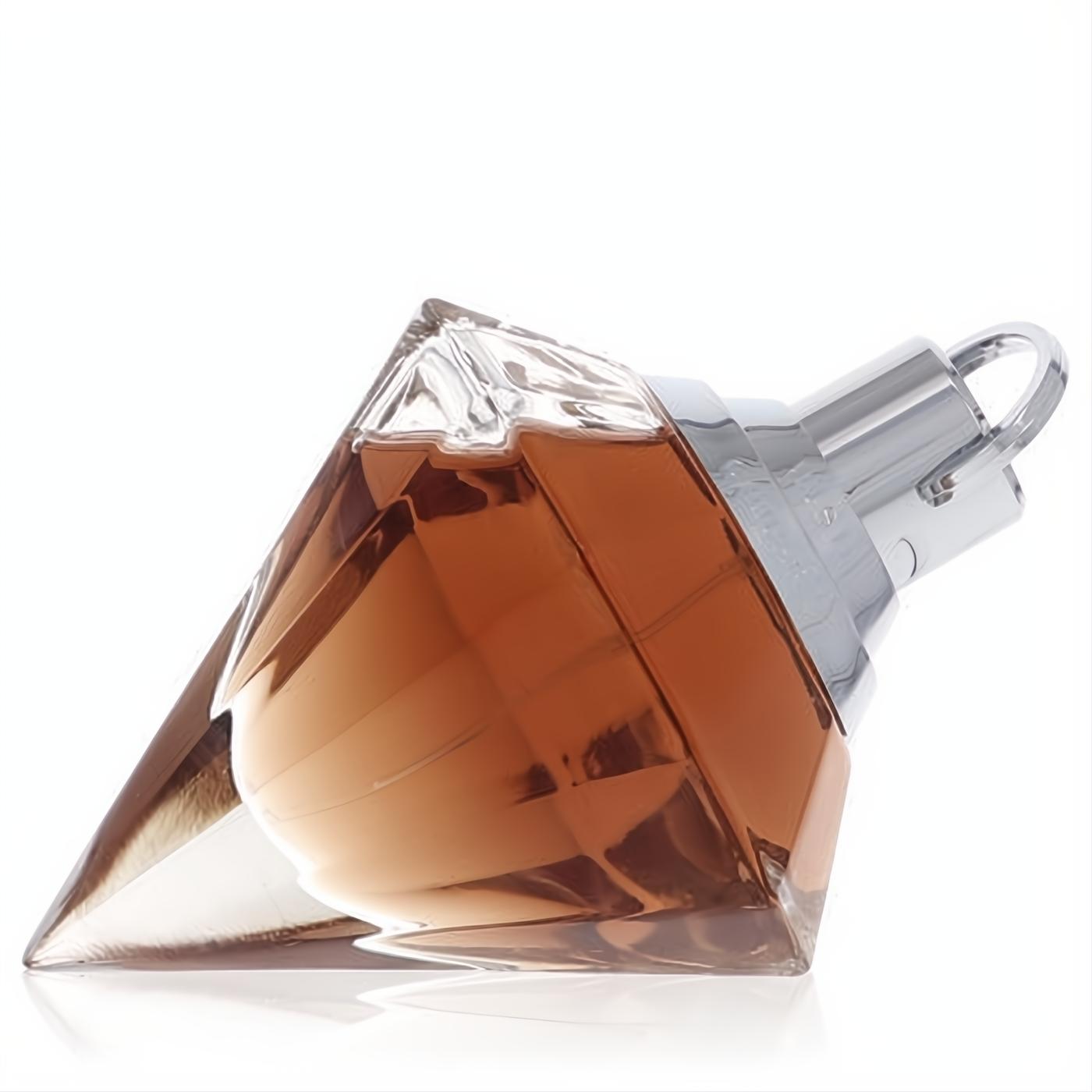 Chopard Wish women's perfume in a sparkling diamond-cut glass bottle with warm amber fragrance and sleek silver cap.