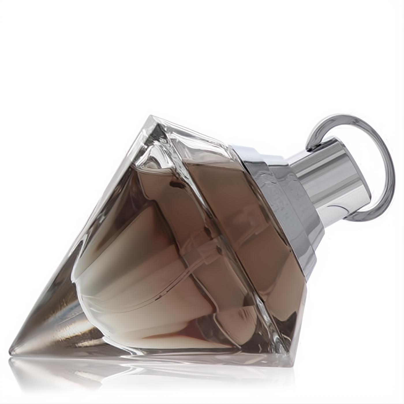 Luxurious Chopard Wish 2.5 oz women's EDP. Faceted clear glass bottle reveals warm amber liquid, topped with a sleek silver cap.